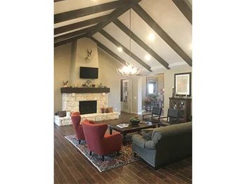 A living room with a fireplace and a tv on the wall.